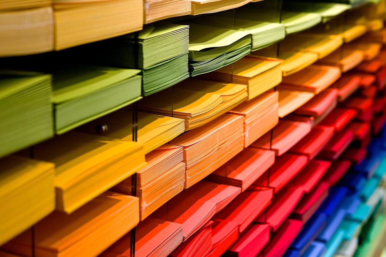 Coloured paper organized on a shelf